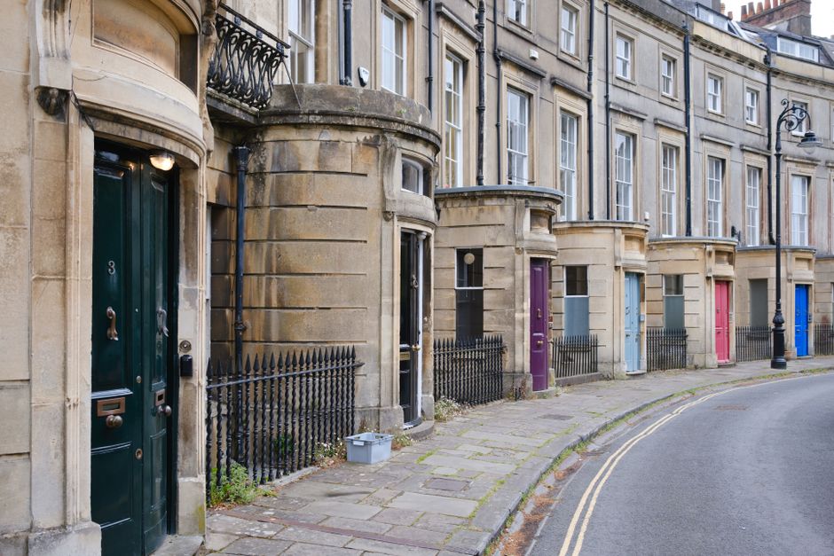 Elegant curved Georgian terrace with colourful front doors on a period street